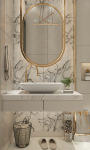 Luxurious bathroom with marble countertops, gold trim and gold faucet for rental property.